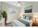 Staged bedroom featuring a bed with stylish blue and white accents, complemented by coordinating decor at 19523 E Buchanan Pl, Aurora, CO 80011