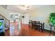 Dining area with hardwood floors next to an updated kitchen and open floorplan to the staircase at 19523 E Buchanan Pl, Aurora, CO 80011