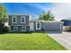Charming two-story home with manicured lawn, gray siding and a two car garage on a sunny day at 19523 E Buchanan Pl, Aurora, CO 80011