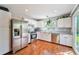 Bright kitchen with stainless steel appliances, white cabinets, hardwood floor and backyard view at 19523 E Buchanan Pl, Aurora, CO 80011