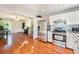 Kitchen with stainless steel appliances that opens into dining and living area with hardwood floors at 19523 E Buchanan Pl, Aurora, CO 80011
