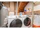 Laundry room with modern, large capacity washer and dryer and built-in shelving at 19523 E Buchanan Pl, Aurora, CO 80011