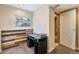 Basement office space featuring unique wood accent wall and bright window at 19523 E Buchanan Pl, Aurora, CO 80011