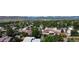 Aerial view captures a neighborhood with lush green trees and mountains in the distance at 8644 S Brentwood St, Littleton, CO 80128