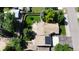 An aerial view showing the house with a charming backyard, patio, lush landscaping, and solar panels on the roof at 8644 S Brentwood St, Littleton, CO 80128