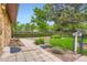 Well-maintained backyard featuring a stone wall, grass, and a manicured garden at 8644 S Brentwood St, Littleton, CO 80128