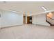 Large basement with tiled floors and overhead lighting at 8644 S Brentwood St, Littleton, CO 80128