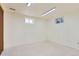 Unfinished basement with painted walls, carpeted floor, and window for natural light at 8644 S Brentwood St, Littleton, CO 80128