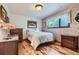 Bedroom with wood floors, window, and wallpaper at 8644 S Brentwood St, Littleton, CO 80128