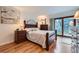 Bedroom with wood floors and a door leading to a balcony or patio at 8644 S Brentwood St, Littleton, CO 80128