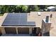 View of the house featuring solar panels, stone accents, garage, updated roof and front entrance at 8644 S Brentwood St, Littleton, CO 80128