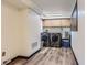 Modern laundry room with stainless steel washer and dryer, utility sink, and cabinets at 8644 S Brentwood St, Littleton, CO 80128