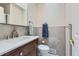 Stylish powder room with modern fixtures, neutral tile, and a vanity at 8644 S Brentwood St, Littleton, CO 80128
