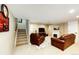 Cozy finished basement with plush carpet, fireplace, and comfortable seating area at 22685 E Calhoun Pl, Aurora, CO 80016