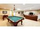 Spacious basement with pool table, foosball, and living area, perfect for entertaining at 22685 E Calhoun Pl, Aurora, CO 80016