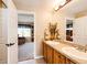 This bathroom includes double sinks and a view into the study at 22685 E Calhoun Pl, Aurora, CO 80016
