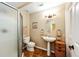 Bathroom featuring a walk-in shower, pedestal sink, and classic tile work at 22685 E Calhoun Pl, Aurora, CO 80016