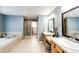 This primary bathroom boasts double vanities, soaking tub, and glass shower at 22685 E Calhoun Pl, Aurora, CO 80016