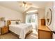 Relaxing bedroom with cathedral ceiling, natural light, and rattan furnishings at 22685 E Calhoun Pl, Aurora, CO 80016