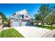 Charming two-story home with a three-car garage, beautiful blue siding, and a well-manicured lawn at 22685 E Calhoun Pl, Aurora, CO 80016