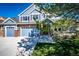 Beautiful two-story blue home with a three-car garage, brick accents, and a well-maintained lawn at 22685 E Calhoun Pl, Aurora, CO 80016