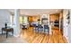 Spacious eat-in kitchen features wood floors, breakfast bar, stainless steel appliances, and granite counters at 22685 E Calhoun Pl, Aurora, CO 80016