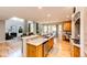 Island sink overlooks living room, with an eat-in kitchen and fireplace in the background at 22685 E Calhoun Pl, Aurora, CO 80016