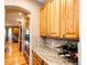 Kitchen with wood cabinets, granite counters, mosaic backsplash, and stainless steel appliances at 22685 E Calhoun Pl, Aurora, CO 80016