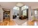 Spacious living room with a high ceiling, fireplace, large windows, and elegant decor, perfect for relaxation at 22685 E Calhoun Pl, Aurora, CO 80016