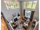 Spacious living room with soaring ceilings, large windows, and a cozy fireplace at 22685 E Calhoun Pl, Aurora, CO 80016