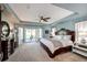 Luxurious main bedroom with a tray ceiling, decorative windows, and elegant furnishings at 22685 E Calhoun Pl, Aurora, CO 80016