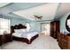 Luxurious main bedroom features a tray ceiling, elegant furniture, and an arched doorway at 22685 E Calhoun Pl, Aurora, CO 80016
