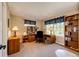 This spacious home office features natural light and a built-in bookcase at 22685 E Calhoun Pl, Aurora, CO 80016