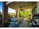Covered patio with comfortable seating, ceiling fan, and views of the serene backyard at 22685 E Calhoun Pl, Aurora, CO 80016