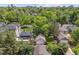 Aerial view of properties featuring backyard details including garage, lawn, mature trees, and patio at 1459 S Elizabeth St, Denver, CO 80210