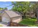 Aerial of property featuring the house, detached garage, mature trees, and lush lawn at 1459 S Elizabeth St, Denver, CO 80210