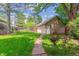 Green backyard with lush lawn and mature trees, offering a peaceful outdoor space at 1459 S Elizabeth St, Denver, CO 80210