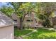 Well-manicured backyard with stone walkway leads to the house and a detached garage at 1459 S Elizabeth St, Denver, CO 80210