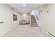 Finished basement area with soft carpeting, seating, and convenient access to the stairs at 1459 S Elizabeth St, Denver, CO 80210