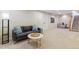 Finished basement with soft carpeting, comfortable seating, and a stylish coffee table at 1459 S Elizabeth St, Denver, CO 80210