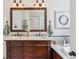 Bathroom featuring a double sink vanity and elegant framed mirror at 1459 S Elizabeth St, Denver, CO 80210