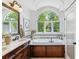 Bathroom featuring a soaking tub, double sink vanity, and an arched window at 1459 S Elizabeth St, Denver, CO 80210