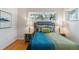 Charming bedroom featuring hardwood floors, ample natural light, and stylish furnishings at 1459 S Elizabeth St, Denver, CO 80210