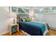 Cozy bedroom featuring hardwood floors, ample natural light, and stylish furnishings at 1459 S Elizabeth St, Denver, CO 80210
