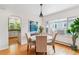 Cozy dining room area featuring hardwood floors, a round table, and views into the kitchen at 1459 S Elizabeth St, Denver, CO 80210