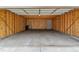 Spacious empty garage interior with concrete floor, wood framing and a utility door at 1459 S Elizabeth St, Denver, CO 80210