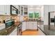 Bright kitchen with white cabinetry, stainless steel appliances, and granite countertops at 1459 S Elizabeth St, Denver, CO 80210