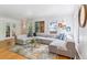 Spacious living room showcasing a sectional sofa, modern decor, hardwood floors and windows at 1459 S Elizabeth St, Denver, CO 80210