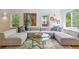 Bright living room featuring a large sectional sofa, colorful artwork, and hardwood floors at 1459 S Elizabeth St, Denver, CO 80210