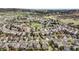 Picturesque aerial view capturing a suburban neighborhood amidst rolling hills and open spaces at 3865 Rawhide Cir, Castle Rock, CO 80104